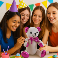 Four women at a birthday party with a white teddy bear wearing a pink bow tie.
