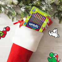 Box of Nerds candy in a red stocking with Christmas decorations around