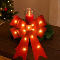 Red felt bow with glowing LED lights for holiday displays
