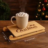 Mug of hot chocolate with marshmallows on a wooden tray with 'Merry Christmas' text, set against a festive background.
