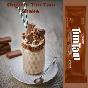Tim Tam shake with chocolate pieces and a Tim Tam bar on a wooden surface.