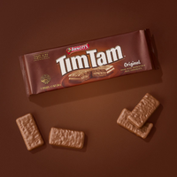 Tim Tam chocolate biscuits with packaging on a brown background
